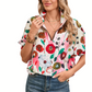 A person wearing the Shewin Floral Print Boho Pop of Color Neckline Blouse with puff sleeves, adorned with multiple necklaces, paired effortlessly with blue jeans.