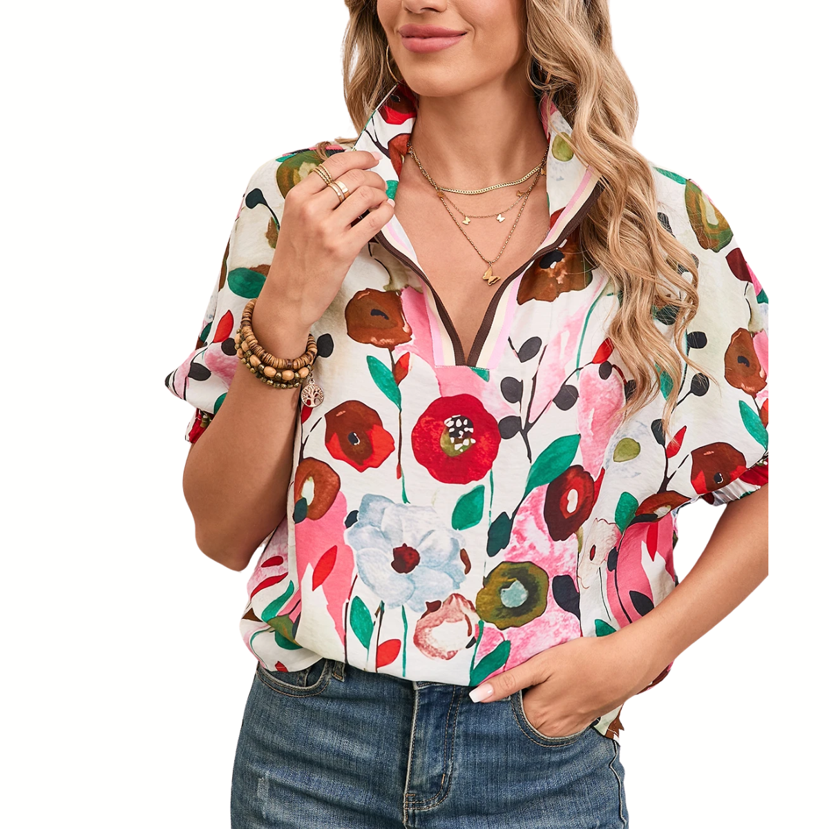 A person wearing the Shewin Floral Print Boho Pop of Color Neckline Blouse with puff sleeves, adorned with multiple necklaces, paired effortlessly with blue jeans.