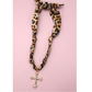 The FASHION GO Handmade Scarf Necklace in assorted colors and patterns features on-trend prints with unique charms, including a gold and pearl cross, shown against a pink background.
