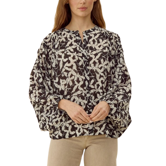 A person wearing a Black Floral Print Blouse from FASHION GO with long dolman sleeves and beige pants.