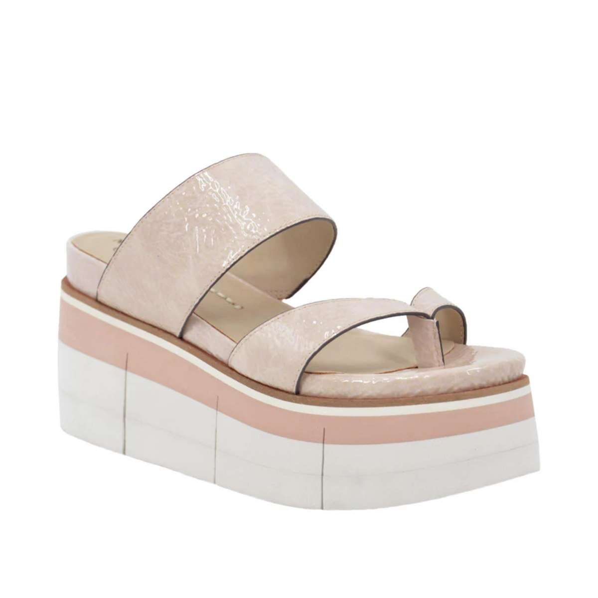 The Flux Platform Sandal in Rosette by Naked Feet from Consolidated Shoe Co is a beige sandal featuring wide crisscross straps made from faux crinkle patent leather, and it boasts a thick, multi-layered sole that seamlessly blends athleisure style with elevated fashion.