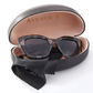 GIFTCRAFT's "Sunglasses in Case - Asst Colors - Large Case - 476766" come in a black oval protective case with a soft interior lining and are labeled "Avenue 9". These stylish shades also include a black cleaning cloth inside the case.