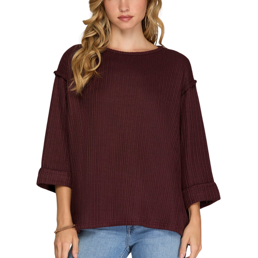 Person wearing She & Sky's 3/4 Folded Sleeve Knit Top in Plum and light blue jeans.