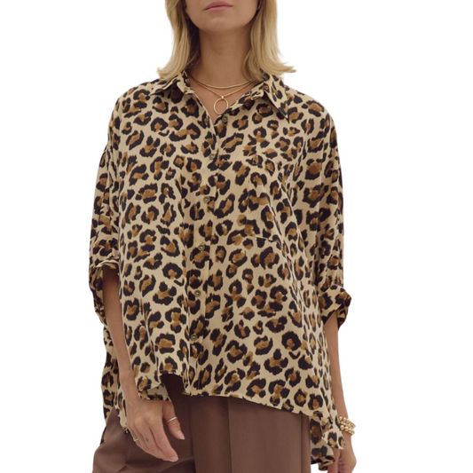 A person wearing a Cheetah Print Oversized Blouse by Entro and brown pants. They are accessorized with a gold necklace and bracelets.