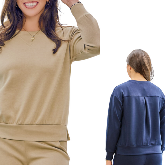 Two women wearing different colored outfits—one in the Malibu Top by Dear Scarlett and beige pants with pleated details, and the other in a navy blue pullover from the travel collection—both standing with relaxed postures.