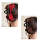 Two images depict a woman's hair styled in an elegant updo, secured with the Hair Claw Clip with Side Bows by Flipflops & Whatnots. The left image showcases a clip adorned with a red bow, while the right image features one with a brown bow.