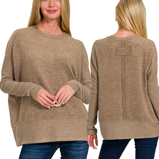 Front and back views of a person wearing a loose-fitting Brushed Hacci Dolman Sleeve Sweater in Mocha by Zenana, paired with blue jeans. The sweater features a round neckline and ribbed hems.