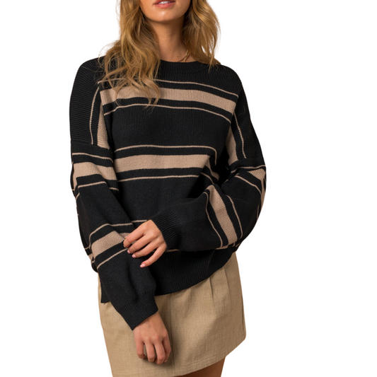 A person wearing the FASHION GO Long Sleeve Striped Sweater in Black, perfect for fall fashion, and a beige skirt stands against a white background. The person's head is partially out of the frame.