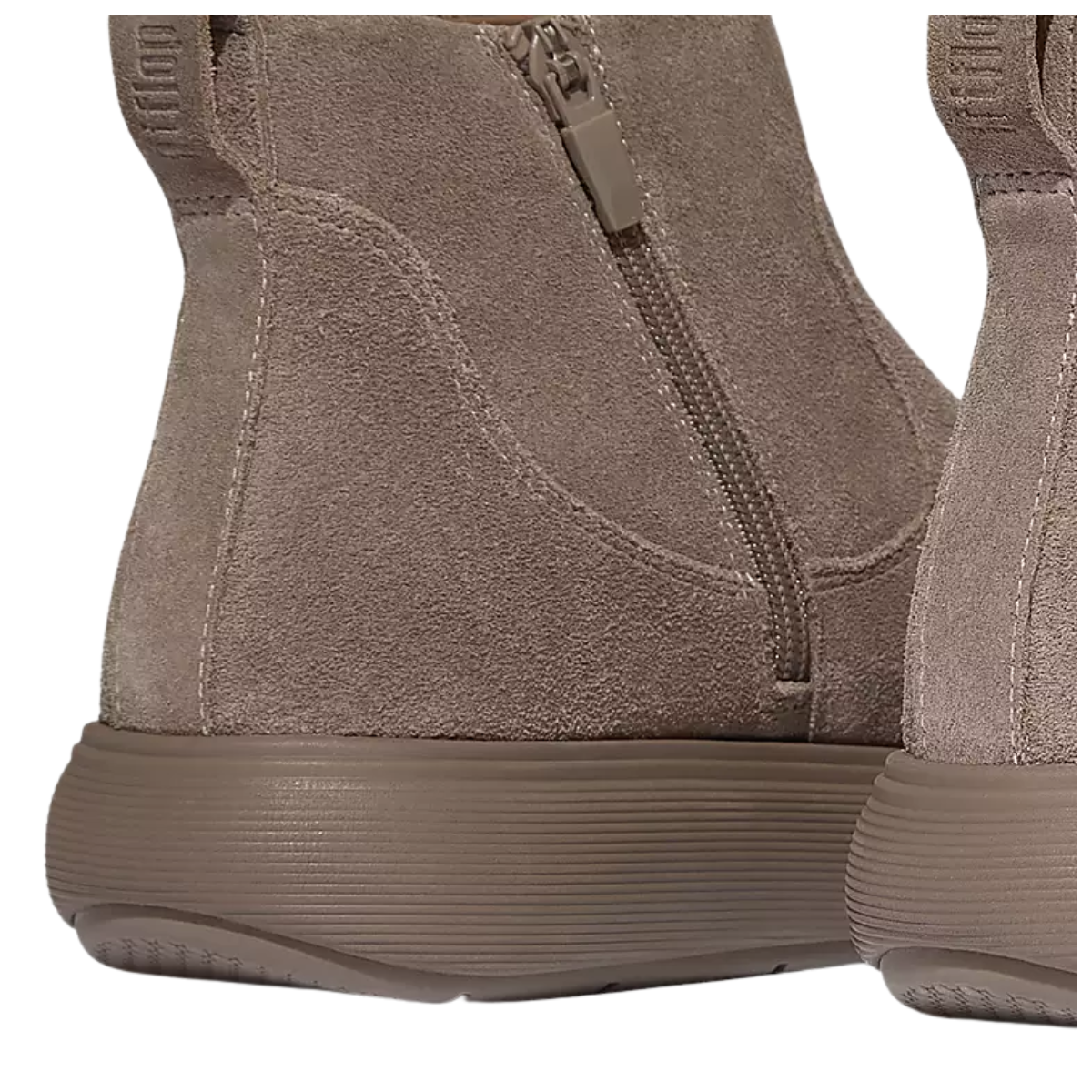 Close-up of the heel and side zipper on Fit Flops iQ-COMFF Suede Zip Ankle Boots in Taupe, showcasing a thick textured rubber sole and iQushion midsole for added comfort.
