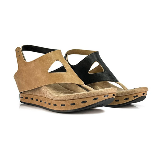 A pair of MODZORI VENITIA BEIGE BLACK mid-wedge sandals by MODZORI, featuring cutout designs, a reversible sandal feature, and dotted detailing on the soles, displayed against a white background.