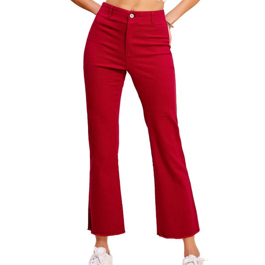 A woman wearing FASHION GO's Soft Washed Stretchy High Waisted Flare Pants in red, paired with white sneakers, stands against a plain white background.