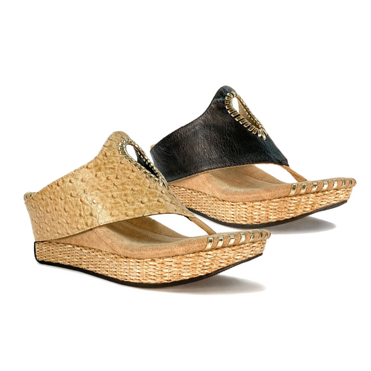 Two pairs of the Lucia Reversible Wedge in Tan/Black by MODZORI, featuring open toes, a stylish cutout pattern, and woven straw soles.