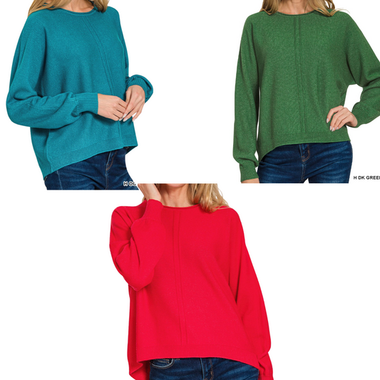 Three women model Zenana's Viscose Front Seam Round Neck Sweater in teal, green, and red—shown from shoulder to hip with blue jeans against a white background.