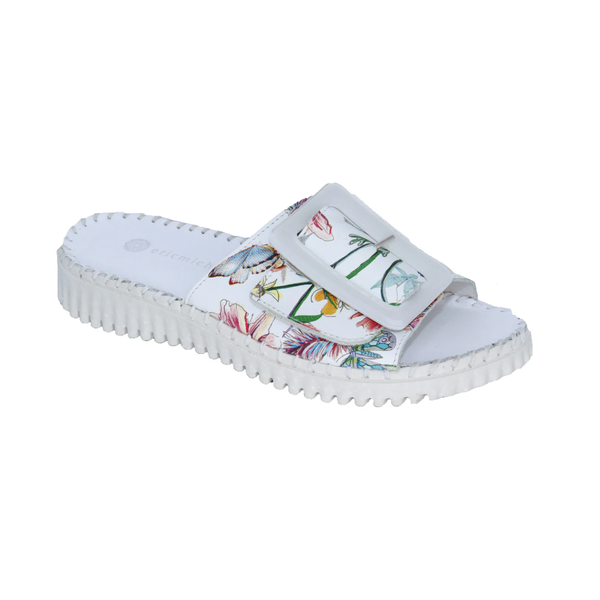 The Darla Leather Slide in Floral Print by Laurevan Shoe Corp features a white floral design, thick treaded sole, and wide adjustable strap. Expertly crafted leather sandals from Italy, offering both comfort and style.