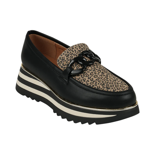 The Good Choice Geneeva Platform Loafer in Leopard is a black vegan slip-on with a chunky sole, leopard print upper, and black chain detail—perfect for making a bold statement.
