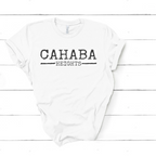 The Faire Distressed Front Cahaba Heights T-Shirt features "CAHABA HEIGHTS" in bold black text, shown laid flat on a white wooden surface.