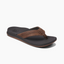 Introducing the Ortho Bounce Men's flip-flop in Brown by Reef, a stylish orthotic sandal featuring a black insole, wide strap, and thong design, displayed against a white background.