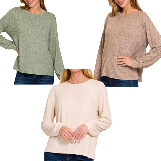 Three women wear Zenana Soft Melange Hacci Round Neck Long Sleeve Tees in green, brown, and beige with blue jeans, shown from shoulders to waist against a white background.