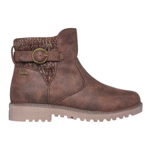 Introducing the Marlie Weekend Chat in Chocolate by Skechers: A fashionable brown ankle boot featuring a knitted texture on the back, a decorative brass buckle, and a flat sole. This vegan-friendly chukka boot from SKECHERS USA INC includes a removable insole for enhanced comfort and a customizable fit.