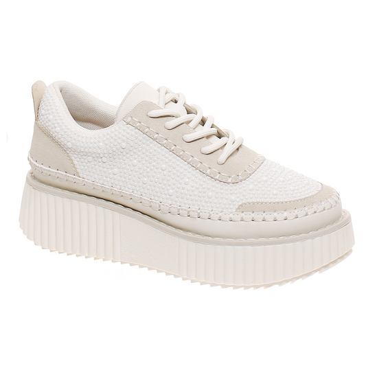 The Sweet Pearls Platform Sneaker in Cream Combo by OLEM SHOE CORP is a single white platform sneaker featuring a textured upper, beige accents, and a thick ridged sole, seamlessly blending the height of fashion with the comfort and style of classic tennis shoes.