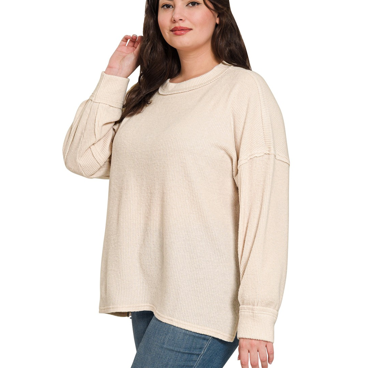 A woman models the Zenana Brushed Ribbed Hacci Drop Shoulder Sweater with jeans, standing against a white background.
