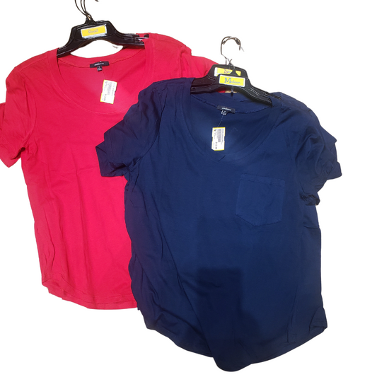 Two AMBIANCE Thin T-shirts by Fashion Go, one in red and the other in navy blue, are displayed on hangers. Each shirt includes a visible price tag, and the navy blue shirt is designed with a chest pocket.