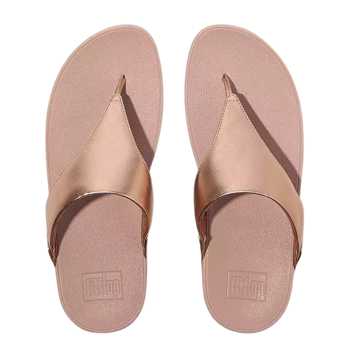 The Fit Flops Lulu Leather Toe Post Thong Flip Flops in Rose Gold by FITFLOP USA LLC feature a classic style, wide strap, metallic finish, and textured footbed, viewed from above.