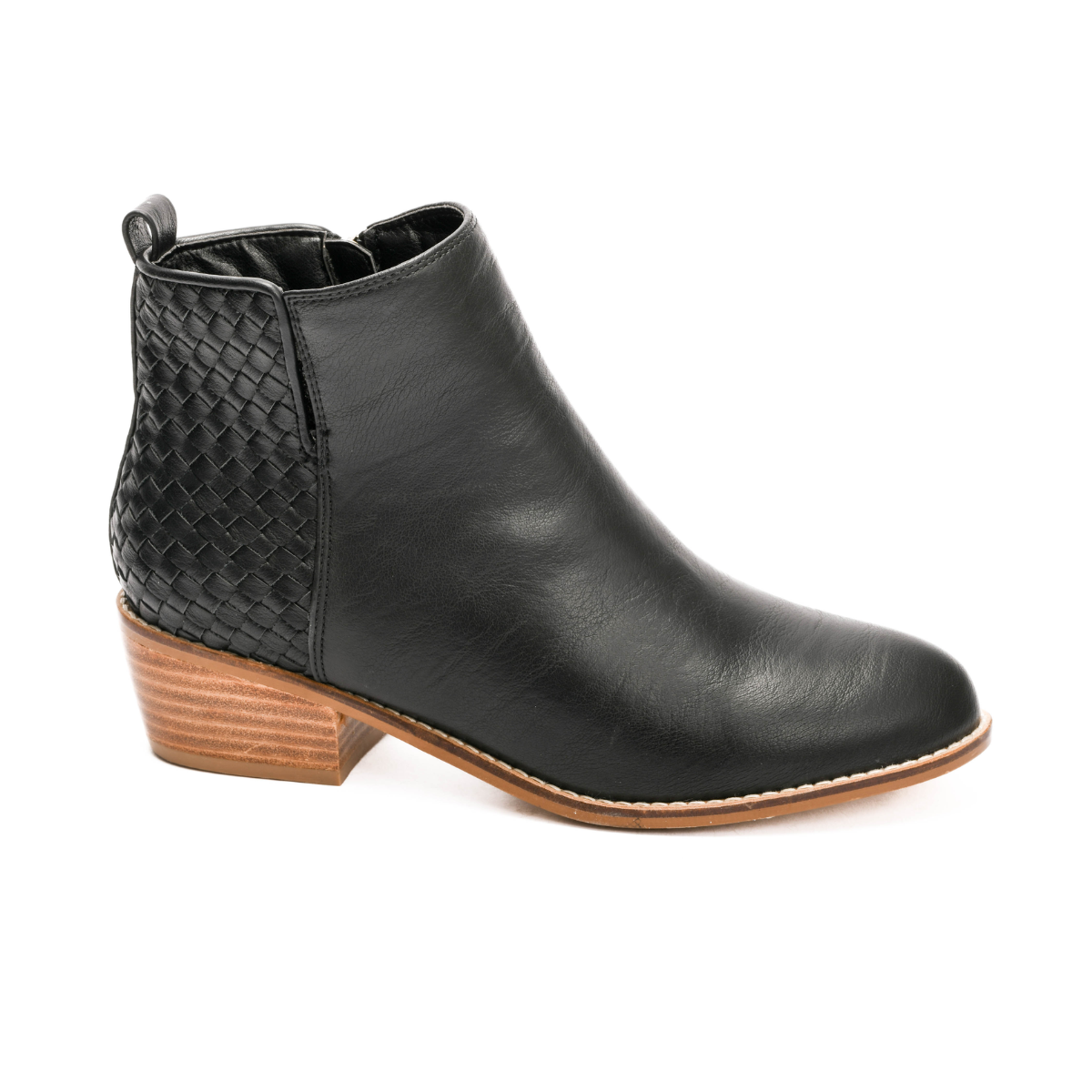 The Half and Half Ankle Bootie in Black by Corky's from CORKY'S FOOTWEAR INC features a fashion-forward black leather design with a woven rear detail and a wooden block heel, ideal for making a statement.