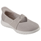 The Audrey Slip-Ons by Skechers, created by SKECHERS USA INC., are light gray shoes featuring a textured knit upper, an elastic cross strap, and a white sole.