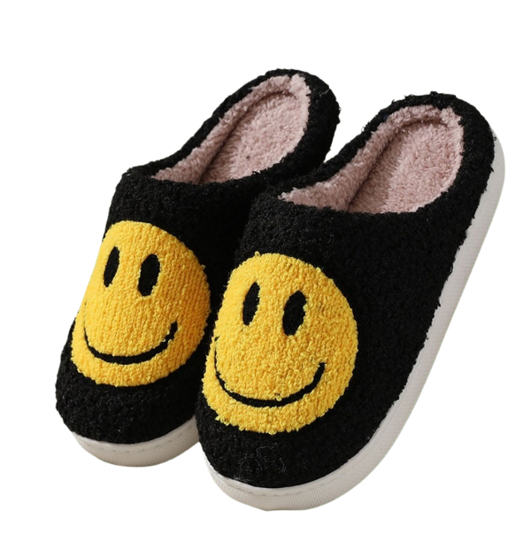 Three pairs of Zenana Smiley Slippers in white, yellow, and black, each with a large smiling face design on top and an easy open back style, are displayed on a white background. Main image