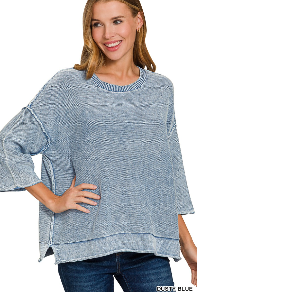 A woman models the Zenana Washed 3/4 Sleeve Boxy Cotton Sweater in dusty blue with blue jeans, posing against a white background.