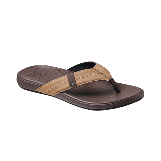 The REEF Cushion Phantom 2.0 is a brown flip-flop sandal featuring textured sole, light and dark brown straps, cushioned footbed, and arch support—ideal for fans of stylish REEF men’s footwear.