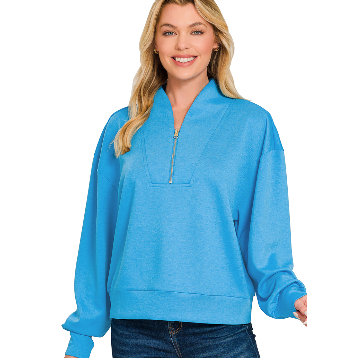 A woman wearing the Zenana Scuba Half Zip Pullover in light blue with jeans stands smiling against a plain white background—an effortlessly cozy layer for any day. Main image