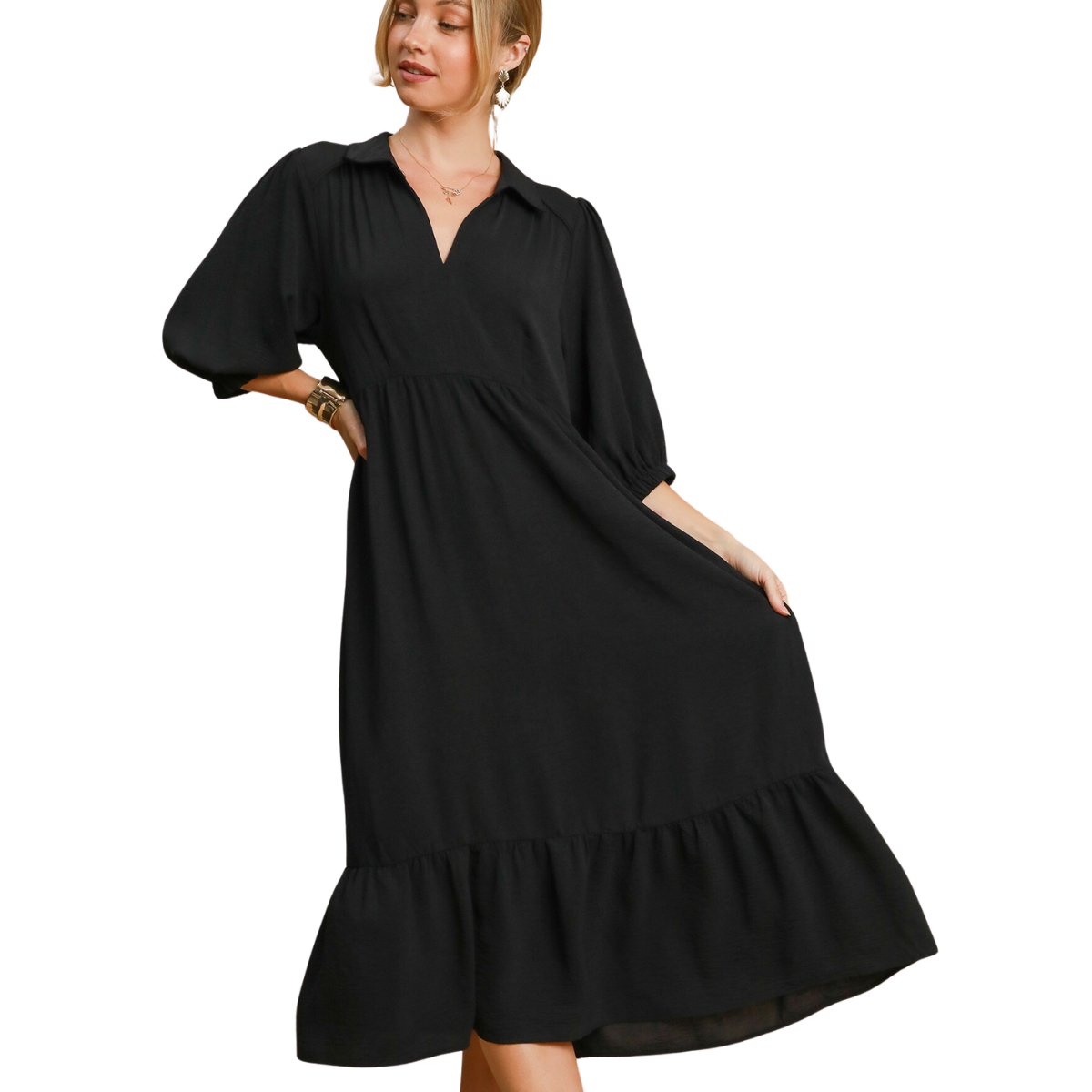 A woman gracefully poses in her sophisticated Midi Dress in Black from FASHION GO, showcasing its stylish puff sleeves and delightful ruffled hem.