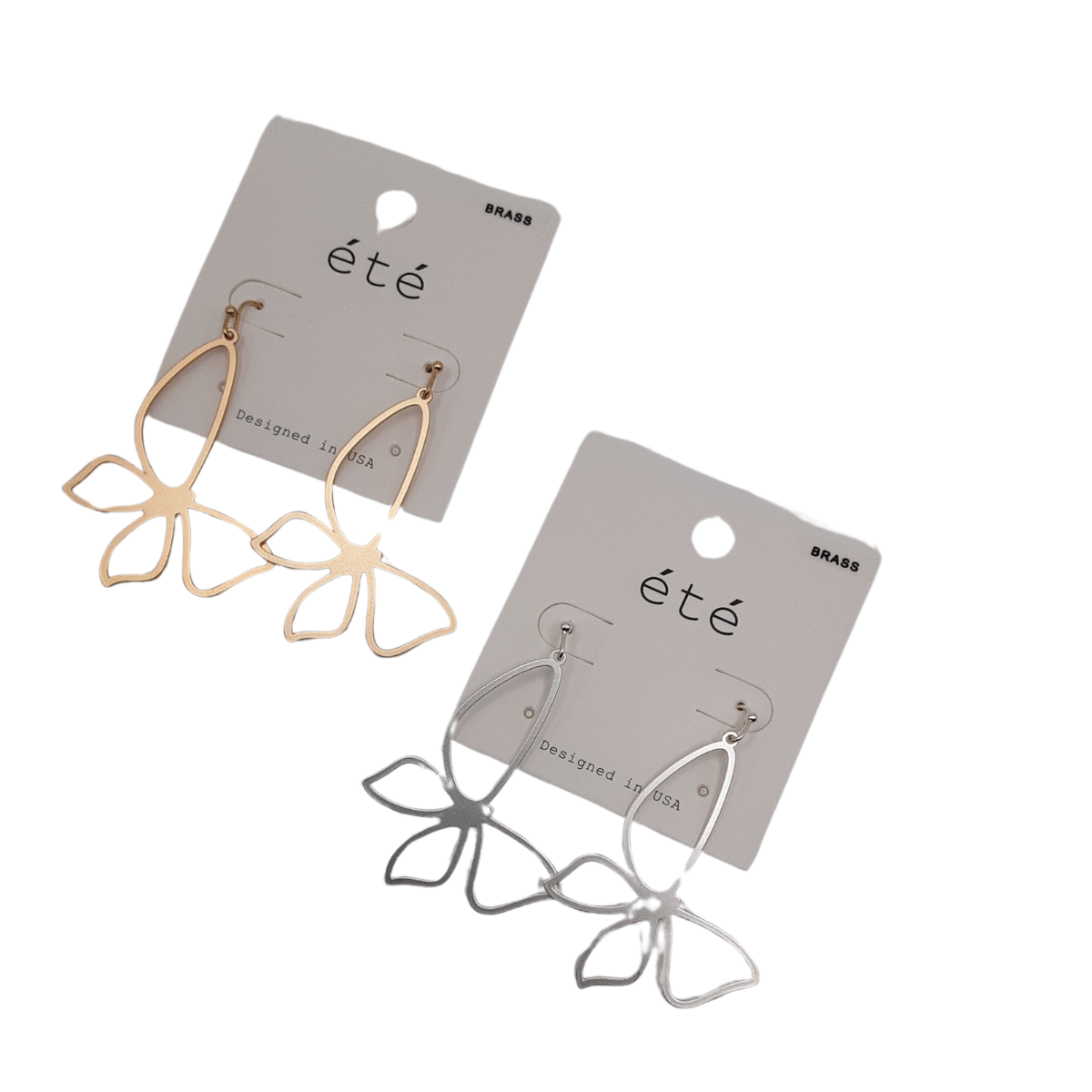 Two pairs of earrings designed like butterflies with open metal work, one pair in gold and the other in silver, attached to cards labeled "été," from the SPECIAL EFFECTS brand. Main image