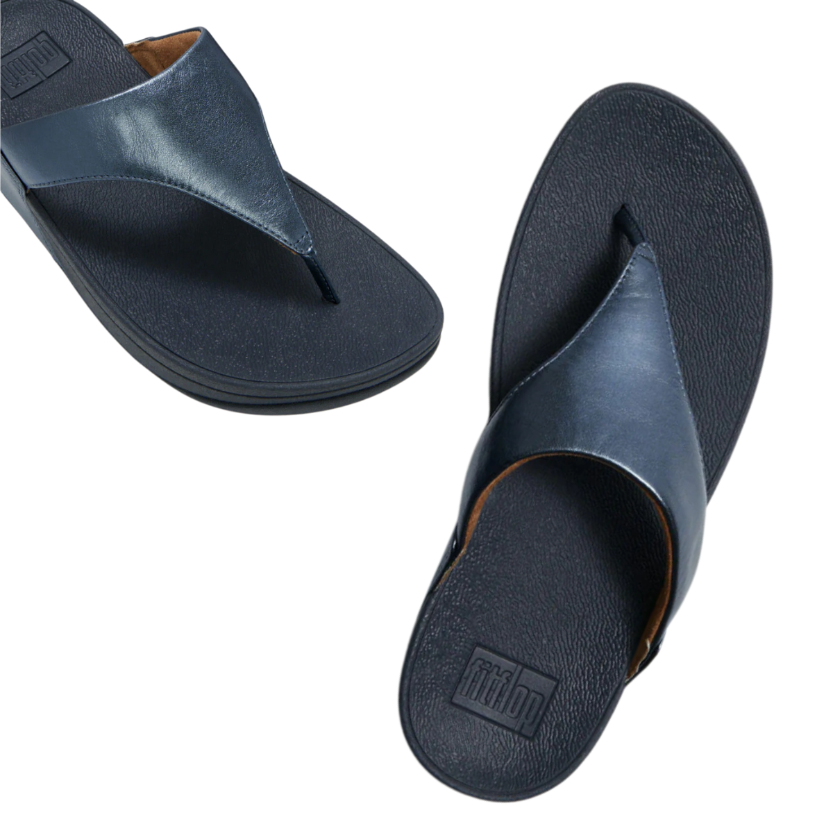 A pair of FITFLOP USA LLC Lulu Leather Flip-flops in Metallic Cosmic Blue with textured soles and Microwobbleboard cushioning, shown from above and at an angle. Main image