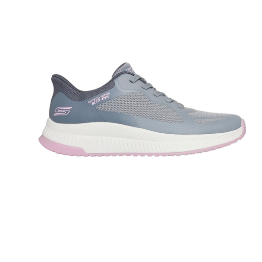 The SKECHERS Slip Ins Staple Look Sneaker is shown in a side profile, featuring a gray and light purple mesh upper, white and pink sole, memory foam cushioning, and a lace-up design.