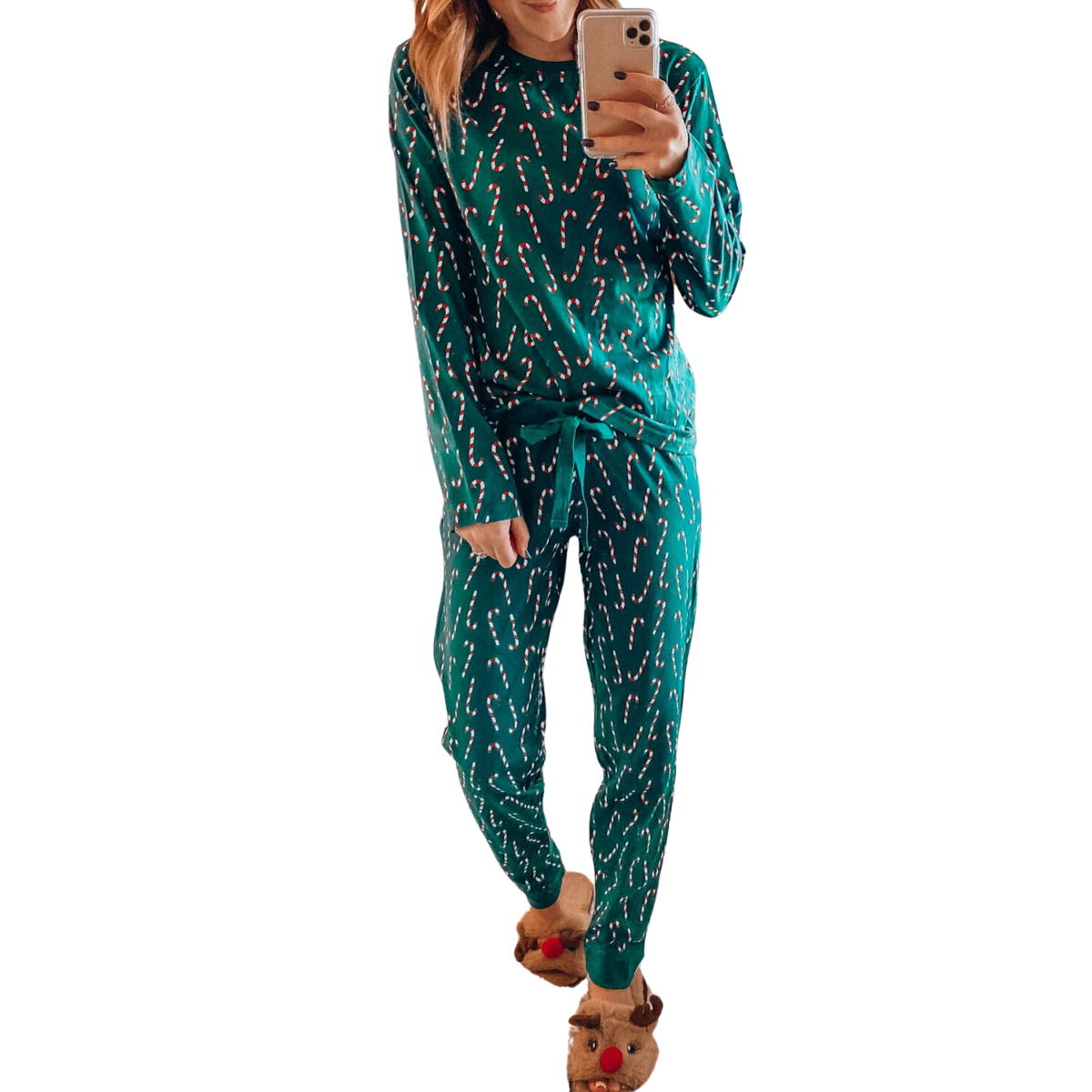 A person wearing the Shewin Green Christmas Candy Cane Loungewear Set, holding a smartphone and sporting reindeer slippers.