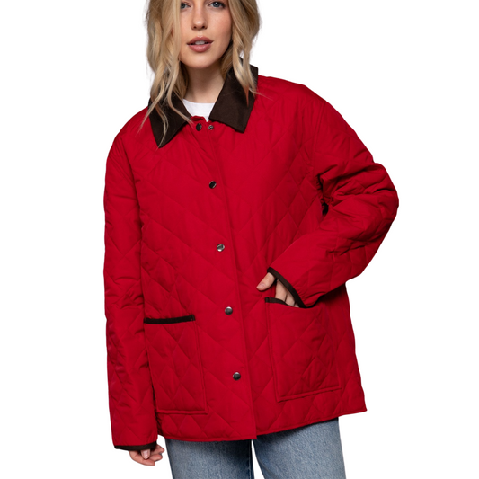 A woman wears the FASHION GO Quilted Puffer Barn Jacket in Red, featuring a black collar and pocket trim, paired with light blue jeans against a white background. This jacket offers classic style with cozy winter comfort.