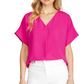 A person wearing a vibrant pink She & Sky V-Neck Short Sleeve Air Flow Blouse, paired with white pants.