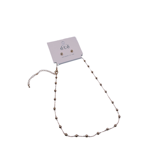 The Gold 16" 3mm Beads Set by SPECIAL EFFECTS includes a delicate necklace with a chain extension and matching stud earrings, all featuring 3mm beads, elegantly presented on a branded card.