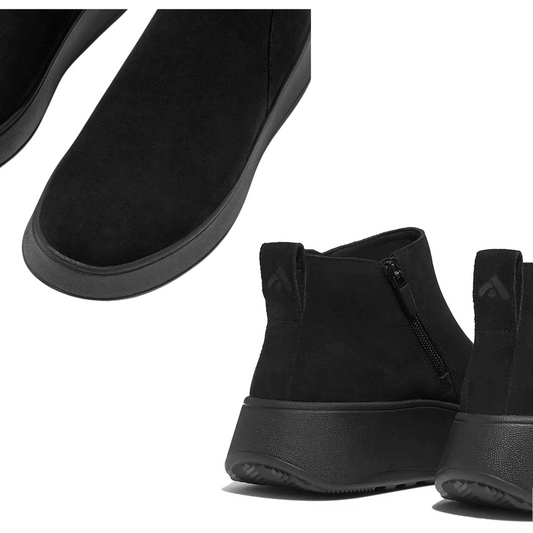 The F-MODE Suede Flatform Zip Ankle Boots in Black by FITFLOP USA LLC are crafted from butter-soft suede and feature a side zipper and a thick rubber sole. The image highlights various close-up angles, emphasizing their texture and ergonomic comfort enhanced by the triple-density Microwobbleboard™ midsole.