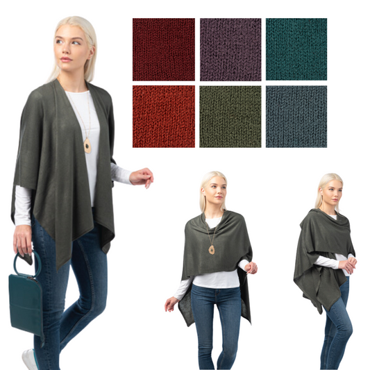 A woman wearing a gray Cardi Wrap by Ganz Inc over a white top and blue jeans is carrying a blue handbag. In the background, six fabric color swatches are displayed: red, burgundy, teal, orange, olive, and charcoal.