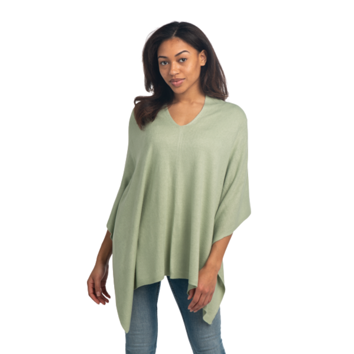 A woman models the Ganz Inc Cape Wrap (Over Head Poncho Style) in light green with blue jeans, standing against a white background.