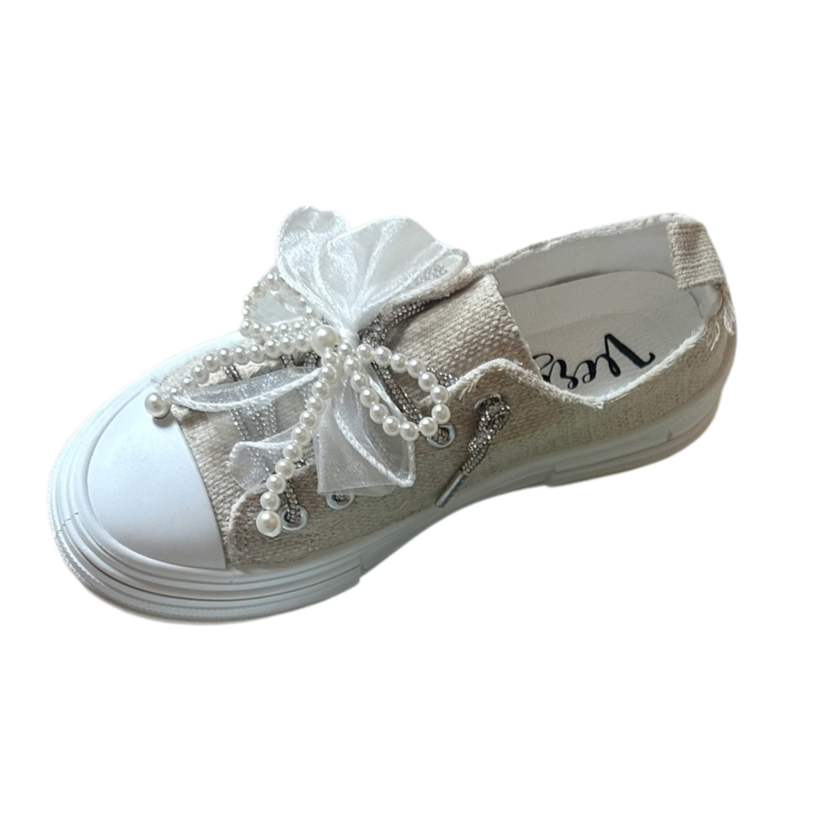 The Aman Sneaker with Pearl and Sparkle Laces by VERY G is a beige everyday shoe featuring a thick white sole, plus decorative sheer fabric bows and faux pearl details on the laces for added style. Main image