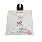 The 16" Bow Necklace by SPECIAL EFFECTS is elegantly displayed on a white card with a printed bow design and text, featuring cubic zirconia details. This exquisite necklace perfectly combines charm and sophistication, making it a must-have piece in your jewelry collection.