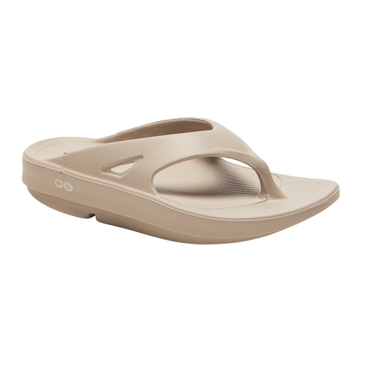 The Oofos OOriginal flip flop in Nomad by OOFOS LLC offers ultimate comfort with its beige rubber design, featuring OOfoam recovery technology, a thick sole, and supportive toe strap.