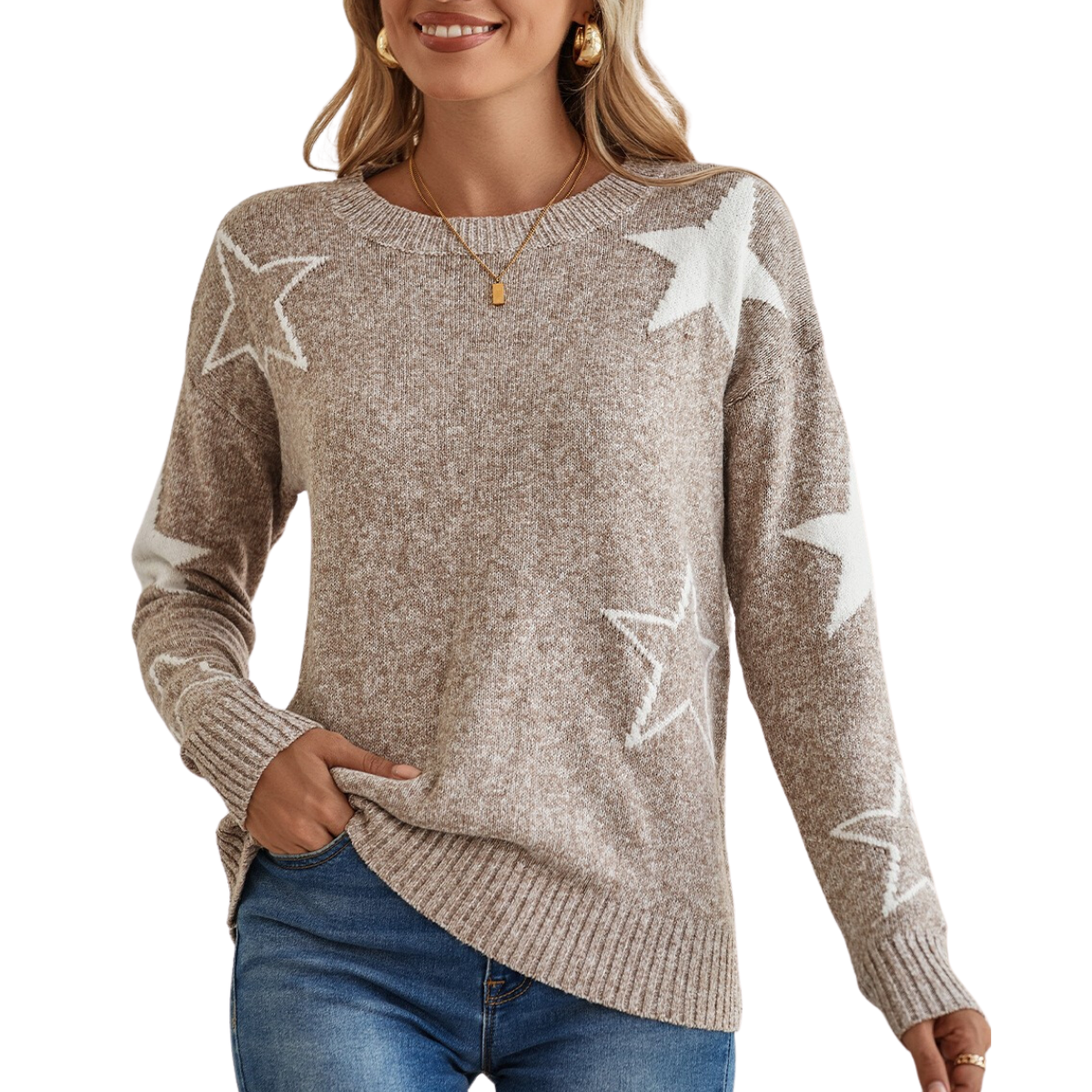 A woman is smiling with one hand in her pocket, and wearing Shewin's Star Pattern Drop Shoulder Knit Sweater in beige rib-knit, adorned with white stars, paired with blue jeans.