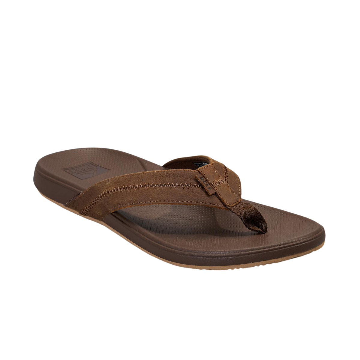 The Reef Cushion Phantom Le 2.0 Men's Flip Flop by REEF is a brown sandal with a textured sole, excellent arch support, and a full-grain leather wide strap cross design. Main image