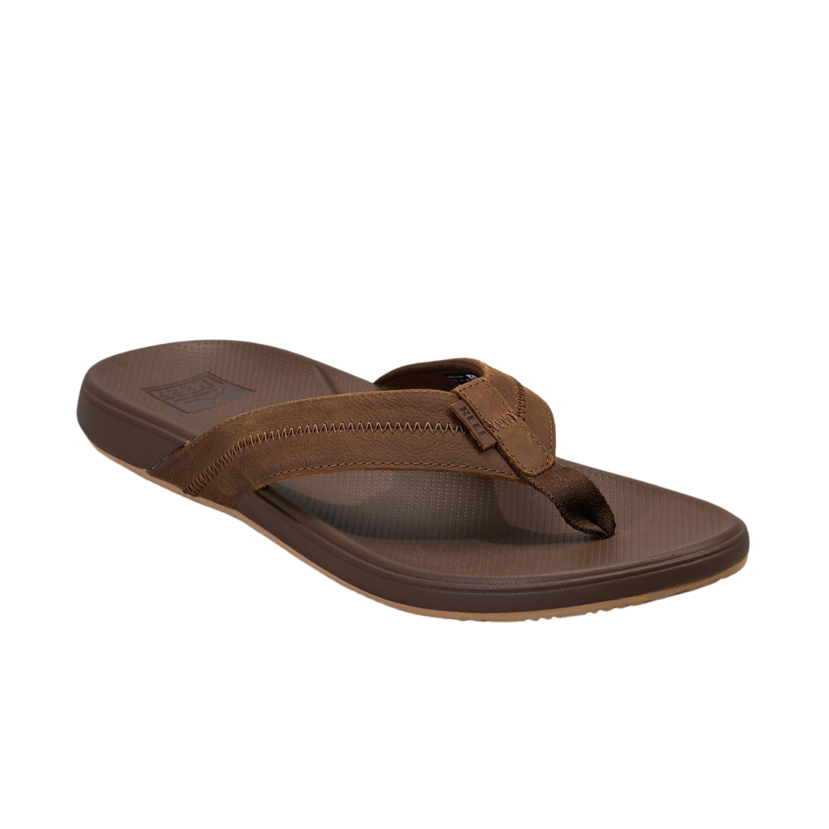 The Reef Cushion Phantom Le 2.0 Men's Flip Flop by REEF is a brown sandal with a textured sole, excellent arch support, and a full-grain leather wide strap cross design.